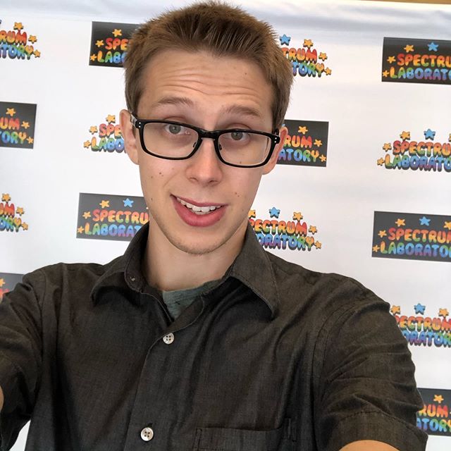 Ben taking selfie in front of film festival backdrop